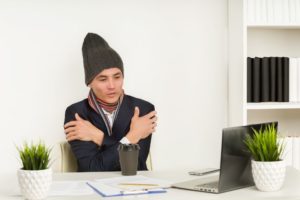 Cold Employee At Desk